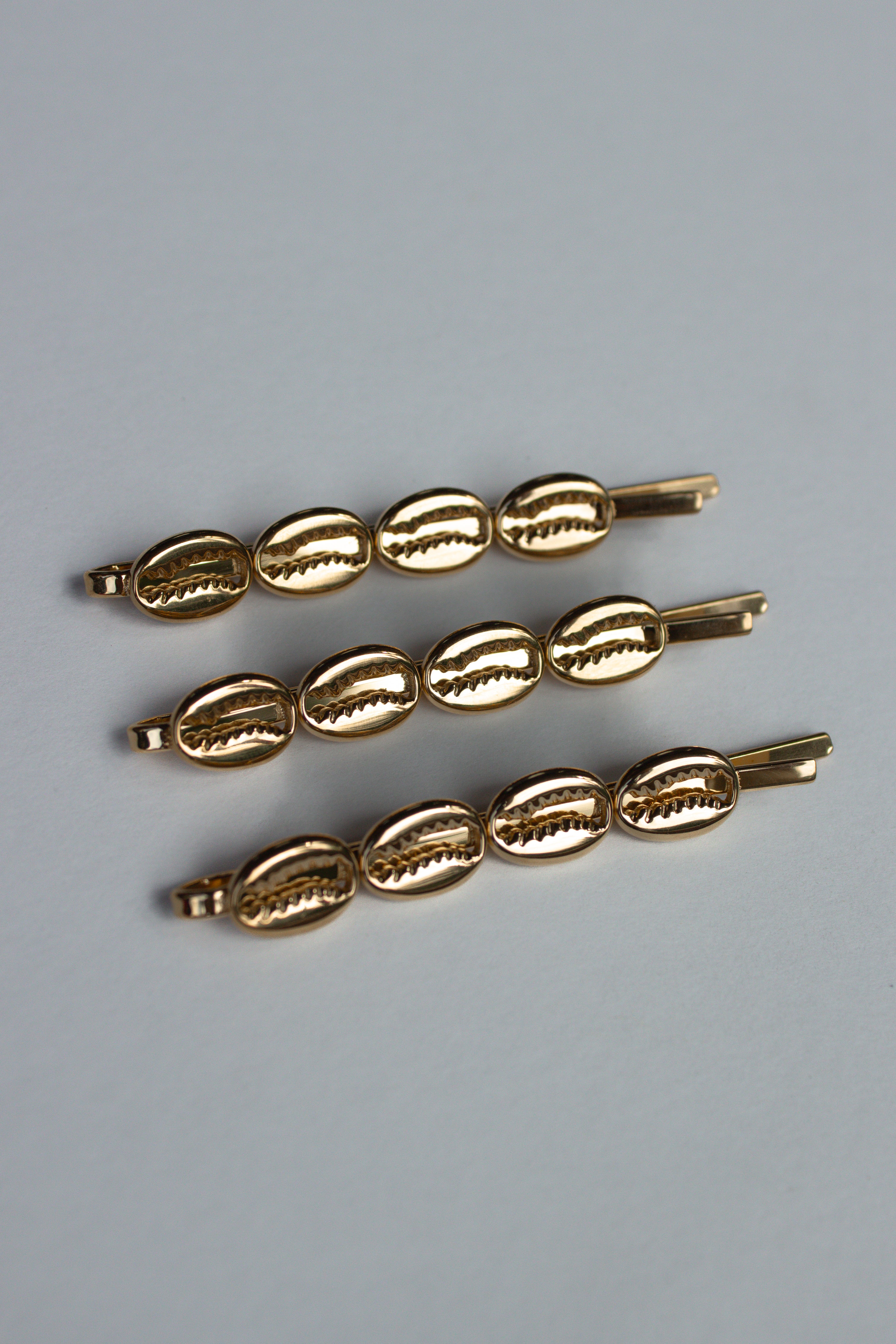 Cowrie Crest Pin