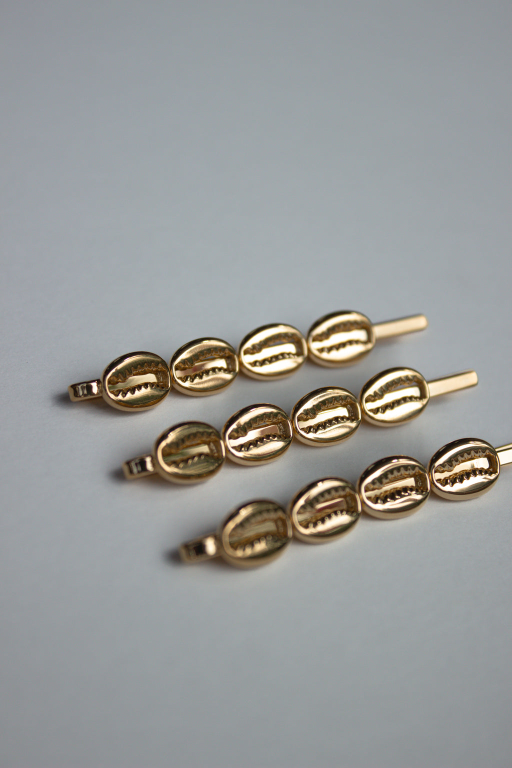 Cowrie Crest Pin
